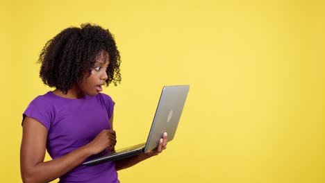 woman reacts to content on laptop with shock and disbelief