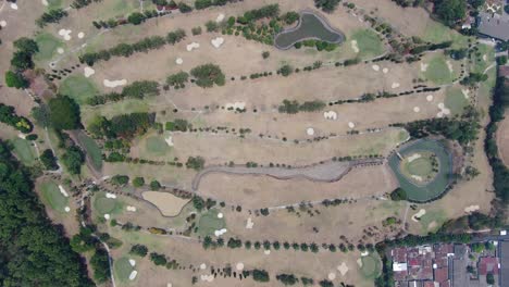 massive golf course field in indonesia, aerial top down view