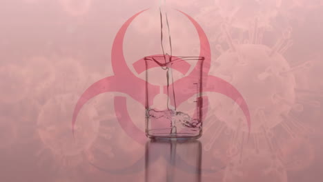 animation of red health hazard sign with liquid dripping and flowing into a beaker on red background