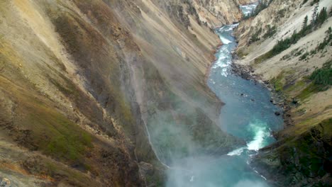 mists arise above the river and gorge of the grand canyon of yellowstone national park