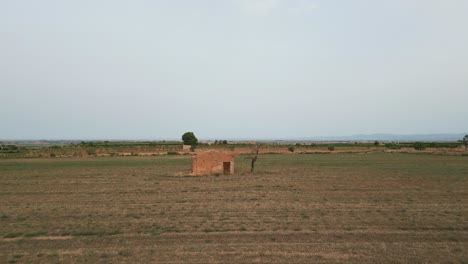 Aerial-forward-view-of-tool-shed-in-a-desert-countryside
