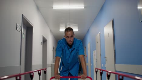 nurse pushing a cart in a hospital hallway