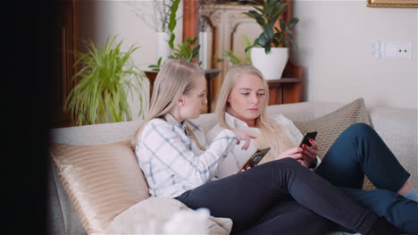 Two-Young-Womans-Doing-Online-Shopping-On-Smartphone-Browsing-Internet-Social-Media-3