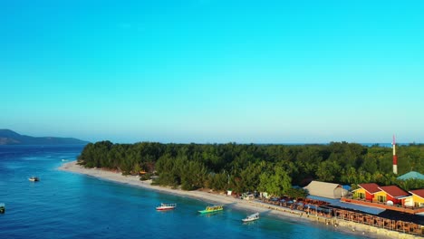 flying-over-an-atoll-island-tropical-Gili-paradise-island,-turquoise-ocean-and-blue-sky-with-clouds-in-the-background