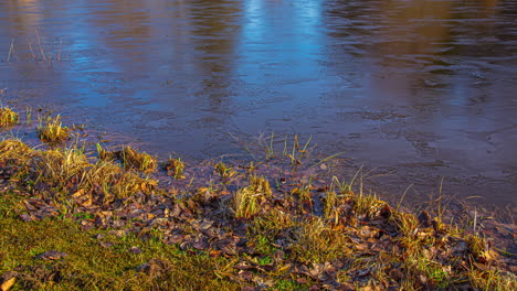 time lapse shot of frozen lake surface and sunrise melting ice during autumnal day - 5k prores