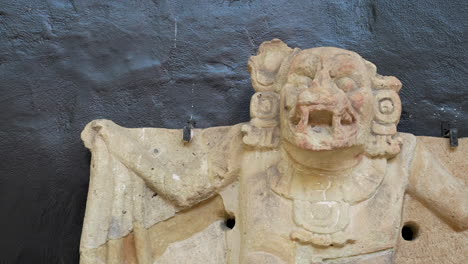 Soft-pan-movement-over-a-mayan-representation-of-a-bat,-at-Copan