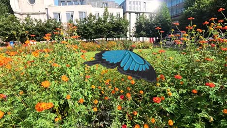 a blue butterfly gracefully flutters through a colorful flower garden, showcasing dynamic movement and vibrant natural scenery
