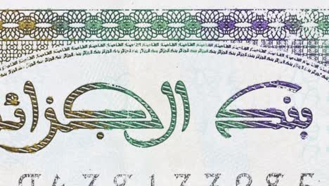 macro pan across an algerian banknote, revealing “bank of algeria” arabic text