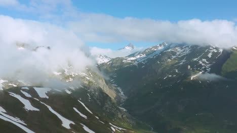 clouds over snow alps near little saint bernard pass in france. - aerial shot