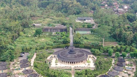 Luxury-private-homes-surrounding-massive-temple-in-Indonesia,-aerial-view