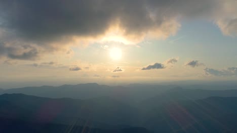 the flight above the mountain on the bright sun background. hyperlapse