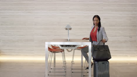 beautiful smart african american business woman working on laptop in lobby