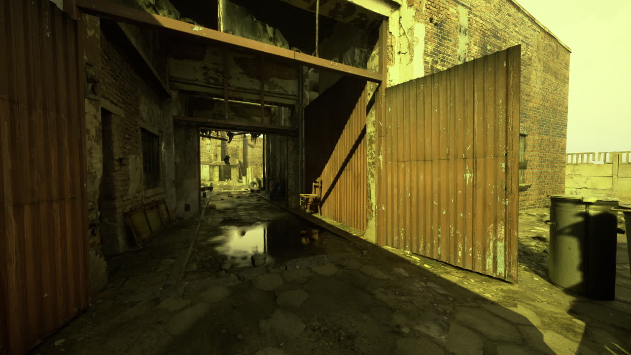 Dusty alleyway with rusted doors at abandoned industrial site