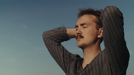 portrait of a man with a mustache outdoors