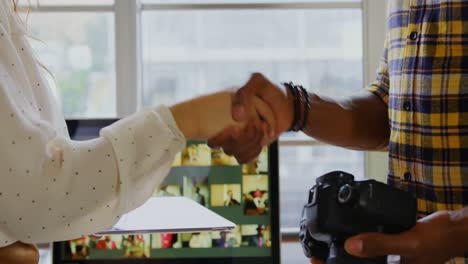 Graphic-designers-shaking-hands-in-a-modern-office-4k