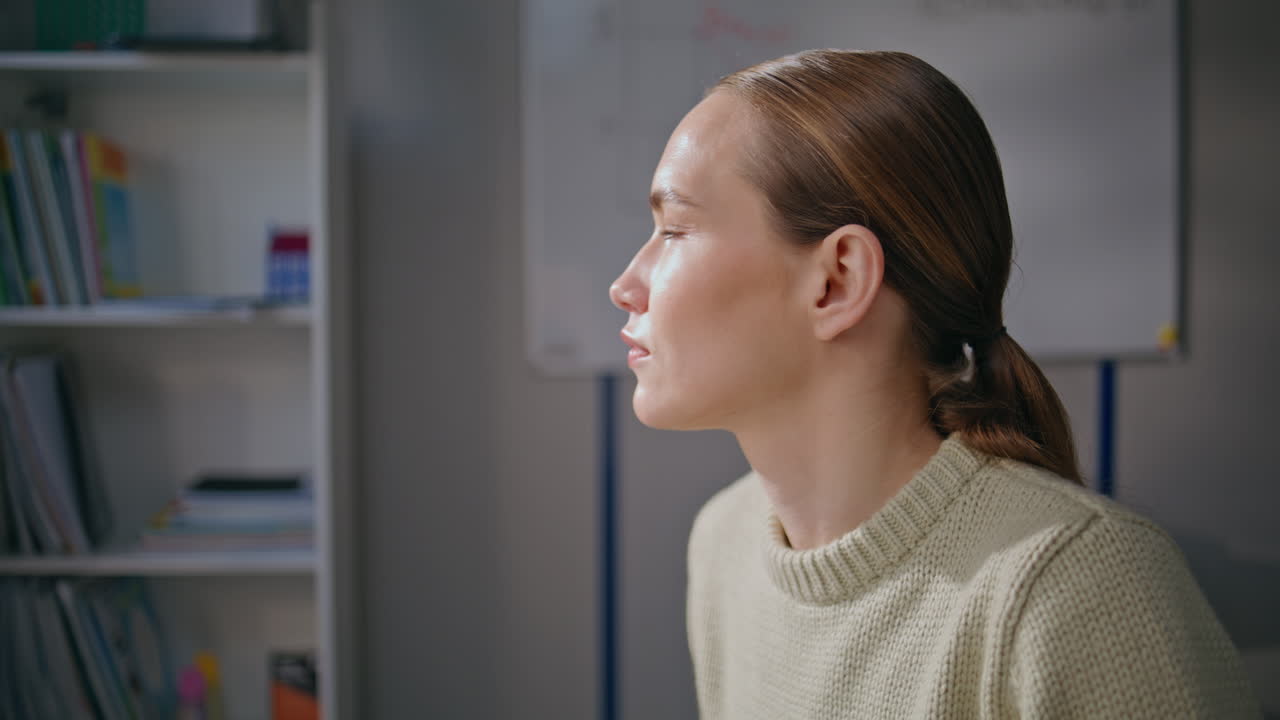 Attentive girl working school at light day closeup. Serious teacher class room
