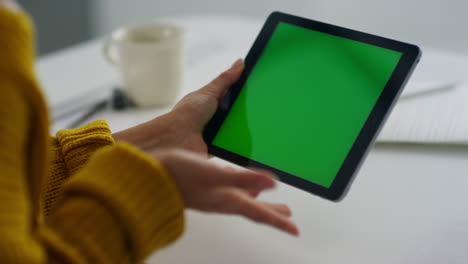 cheerful woman having video talk on green screen tablet