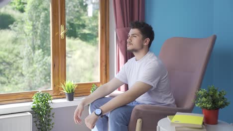 christian man praying in front of the window.