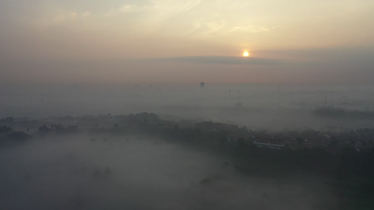 Sunrise over a Foggy City