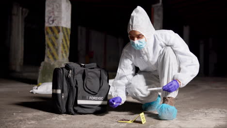 a forensic scientist collects evidence at a crime scene