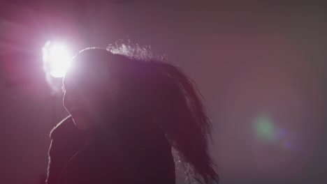 Backlit-Studio-Shot-Of-Casually-Dressed-Young-Woman-Dancer-Dancing-In-Spotlight