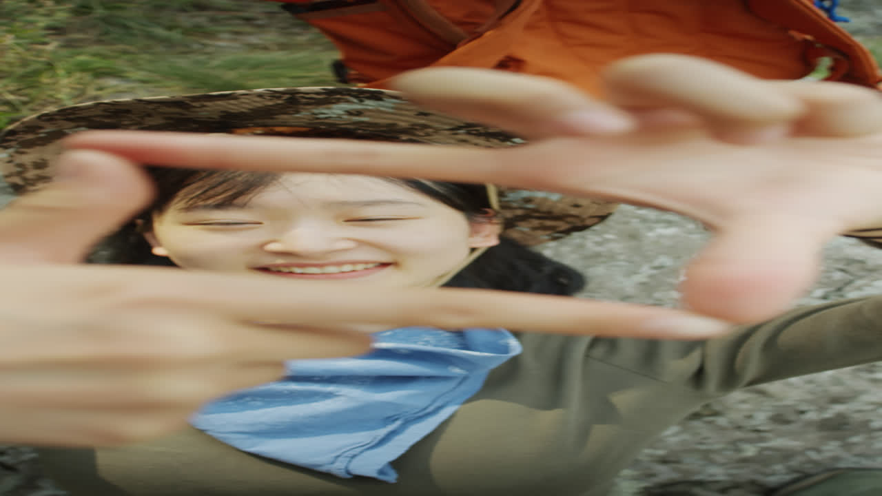 Joyous Asian Girl Looking through Fingers Square