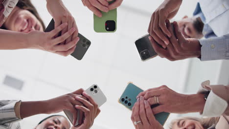 diverse group holding smartphones in unity