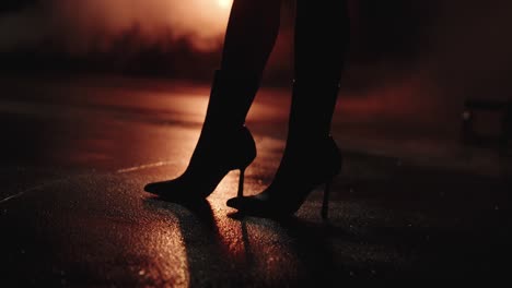 black women's high heels with wet street. street reflected leds. in slow motion