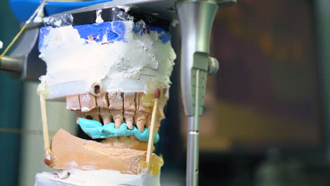 static shot of a dental mould being imprinted within a dental laboratory