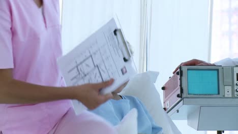 little girl in hospital talking to a nurse and a doctor