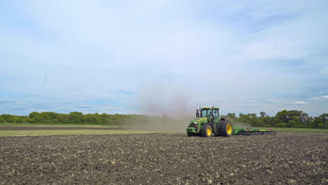 agricultural tractor working on arable land. farming industry