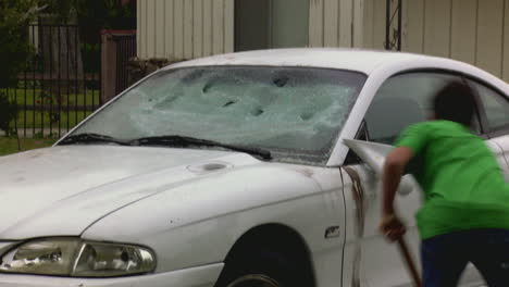 A-man-destroys-his-car-with-a-sledgehammer-3