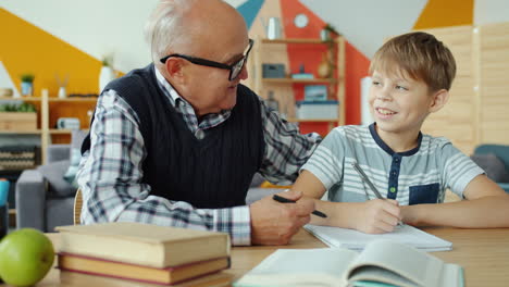 grandfather helping grandson with homework