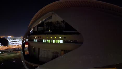 backwards revealing shot of valencia arts museum , shot in valencia at night over the christmas period