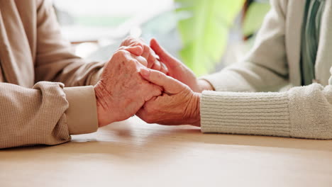 elderly couple holding hands