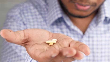 person holding pills in hand