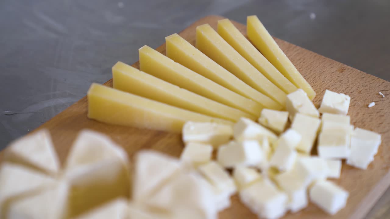 Cheese Board (Charcuterie Board) - Camembert Cheese Cut Into Wedges, Gouda, And Goat Cheese. - closeup shot