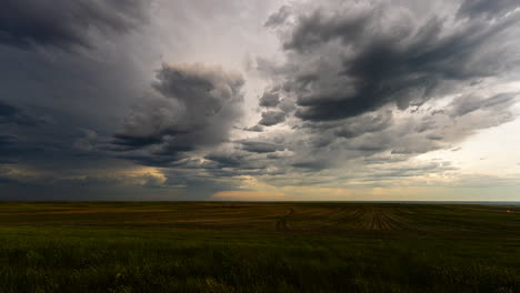 dark clouds drift away as light fades in late evening time lapse