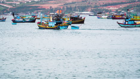 colorful vietnamese fishing boat leaving harbor on calm ocean water, static view