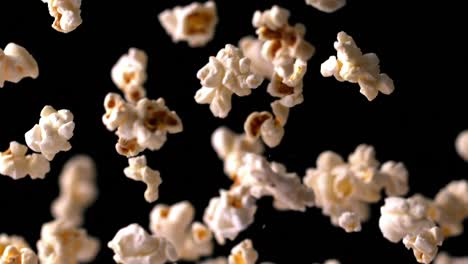 Popcorn-bouncing-against-black-background