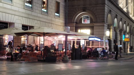 Restaurant-tables-outside-at-night-on-sidewalk