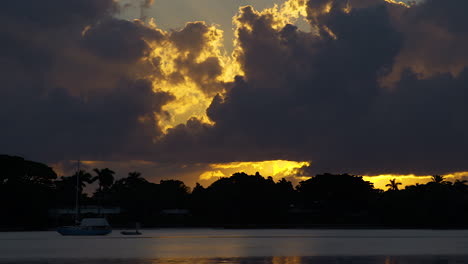 dramatic clouds over moored boat in south florida inlet