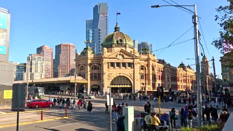 people crossing street near flinders street station