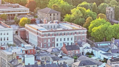 drone ascends city centre of barnsley, classic english town with bright sunlight spread across historic buildings