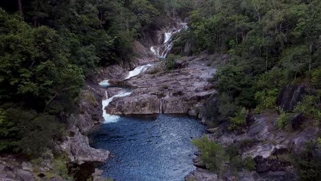 aerial dolly back over swimming hole at clamshell falls in cairns