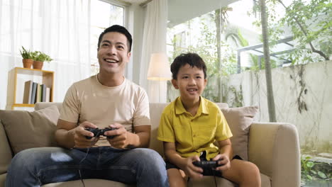 asian man and boy in the living room