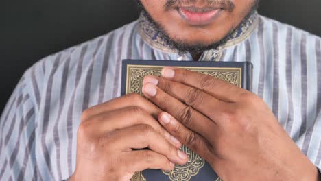 man praying with the quran