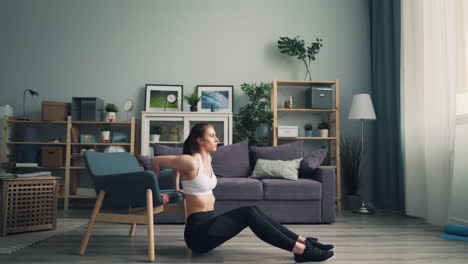 woman doing chair dips at home