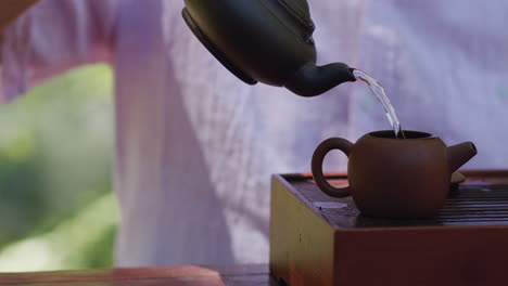 man pours water into teapot, steeps tea, relaxing pleasure, calming