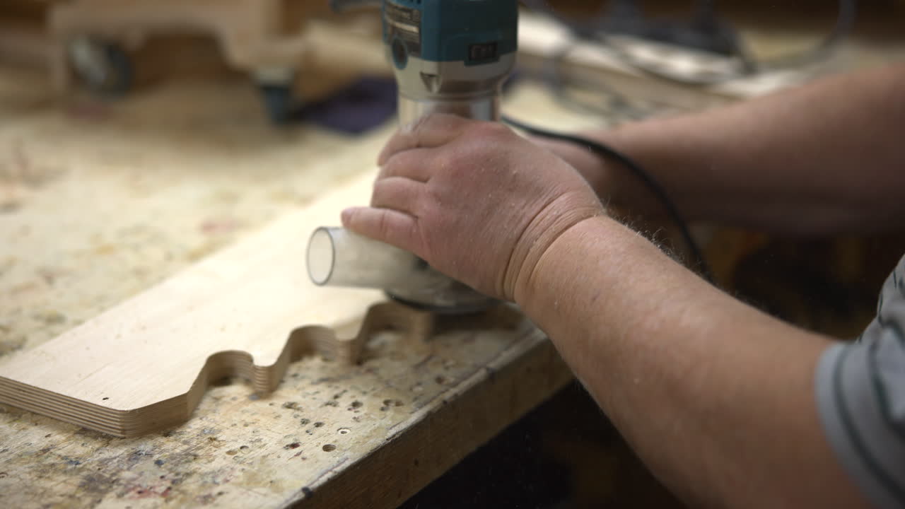 Handheld Router Shaping Edge Caucasian Shaper Carving Profile Along Board, Dust Particles In Air, Steady. Media